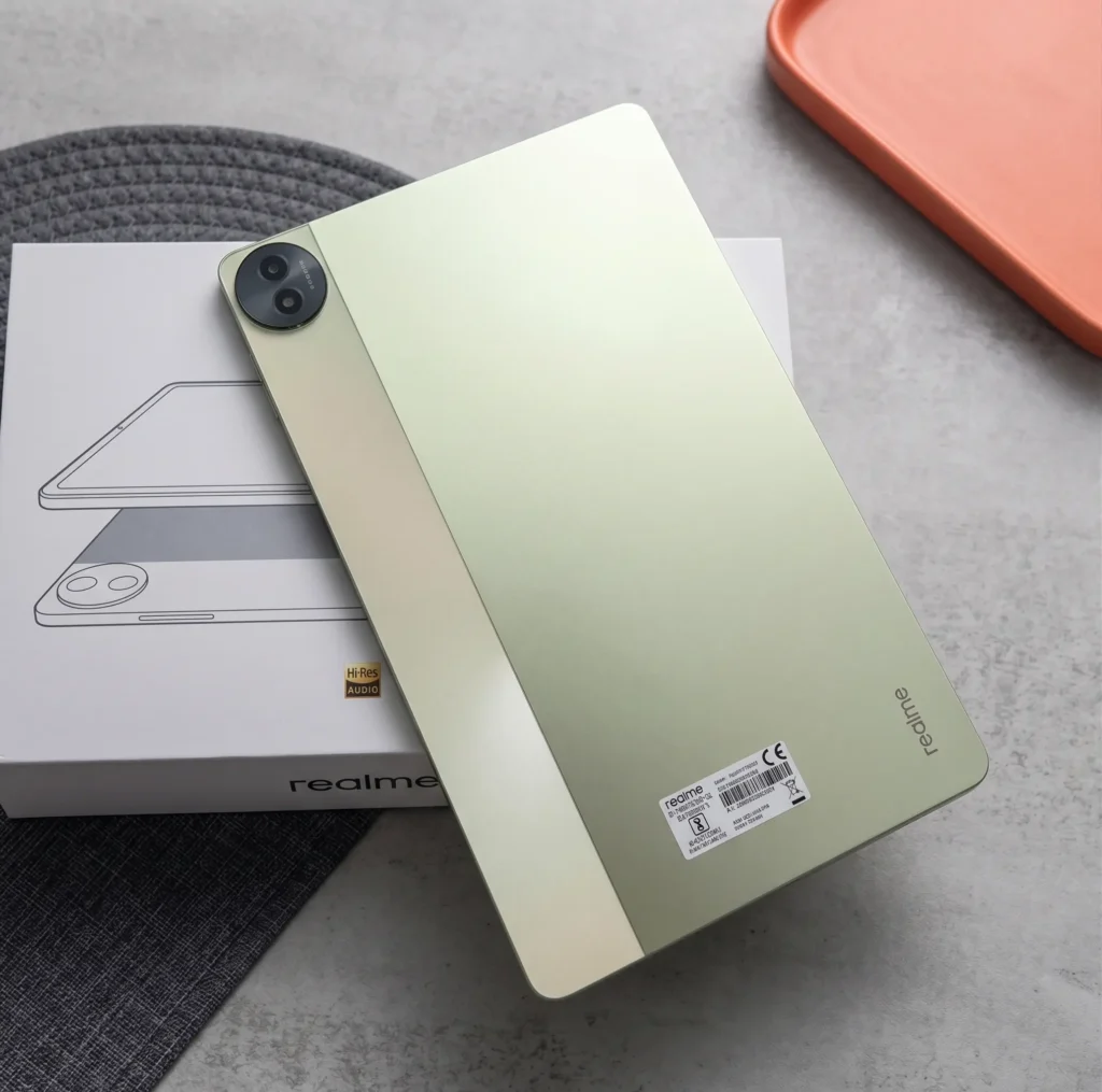 Close up back design of Realme Pad 2 tablet in Inspiration Green color resting on its white retail box